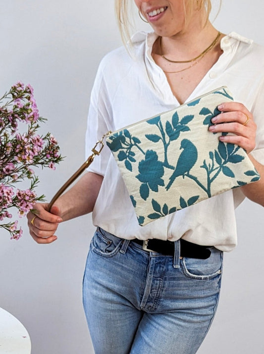 Ash & Rose bird silhouette wristlet purse featuring a sleek design and compact size, perfect for carrying essentials.