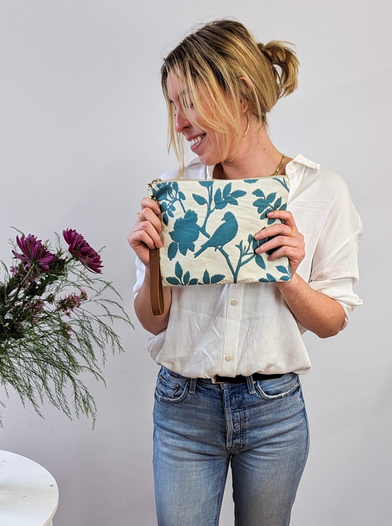 Ash & Rose bird silhouette wristlet purse with wrist strap, featuring a sleek design and compact size for everyday use.