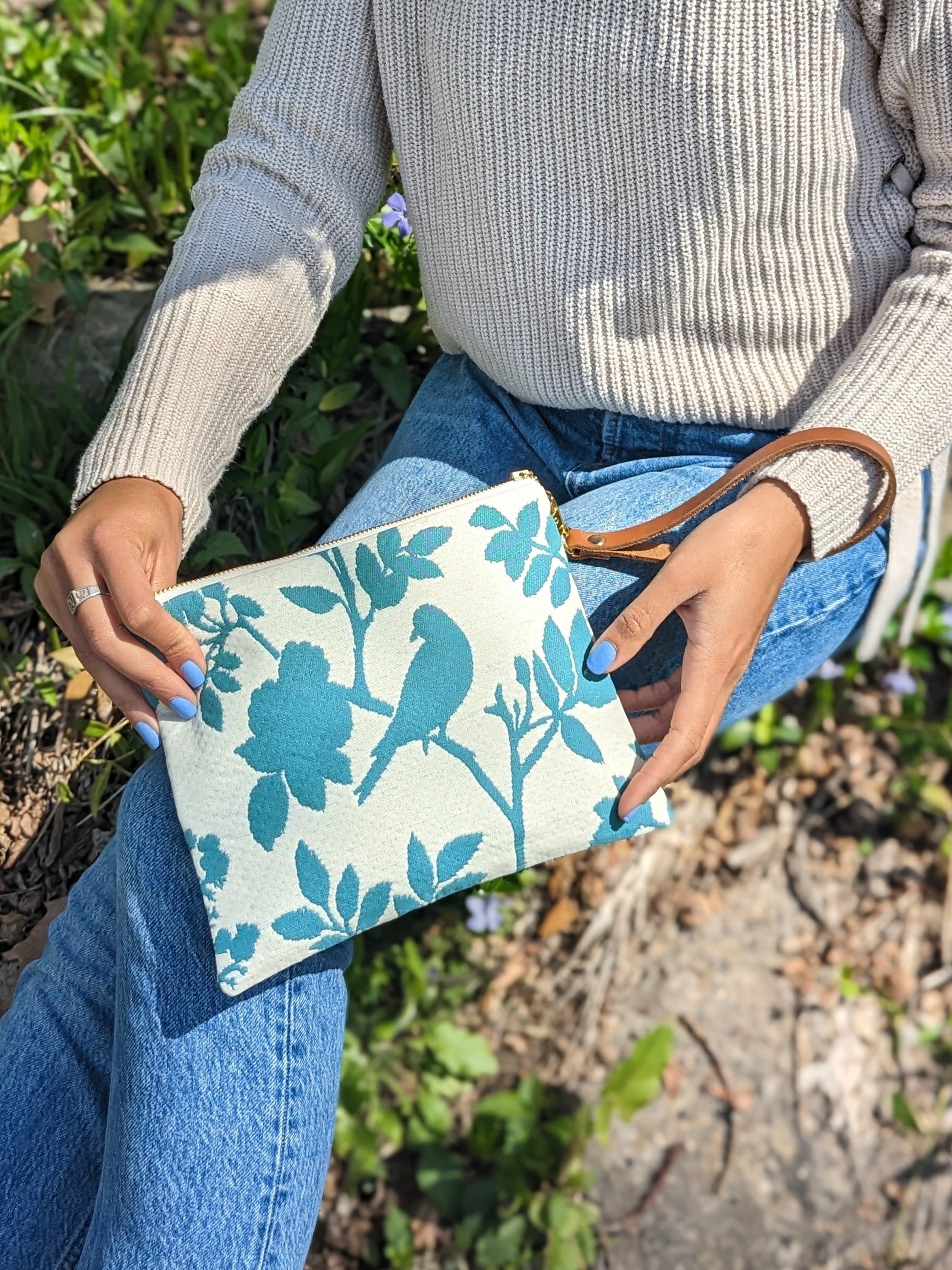Ash & Rose bird silhouette wristlet purse showing a compact leather wristlet with a bird design silhouette on the front.