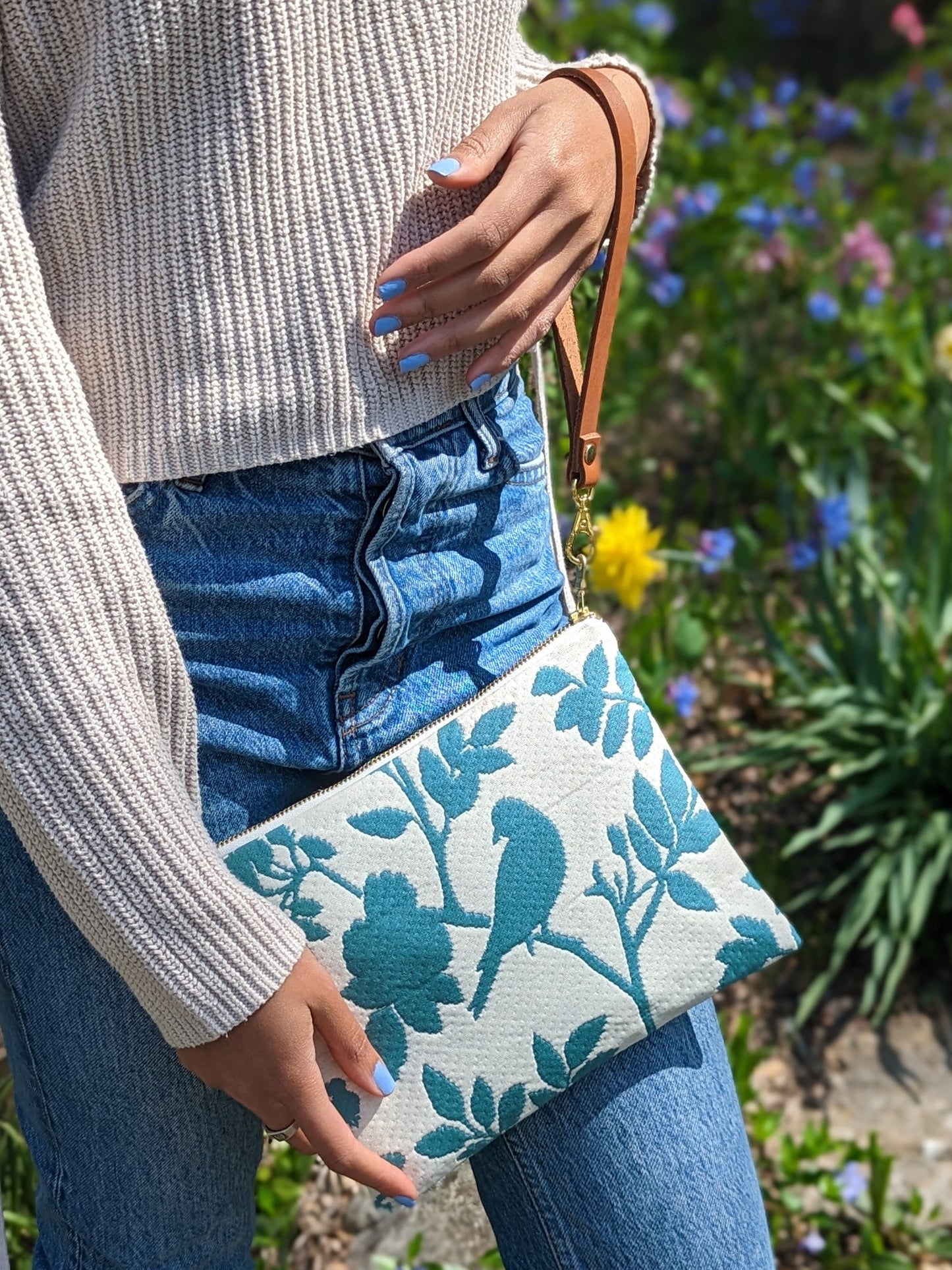 Ash & Rose bird silhouette wristlet purse featuring a compact design with a wrist strap and stylish bird pattern.