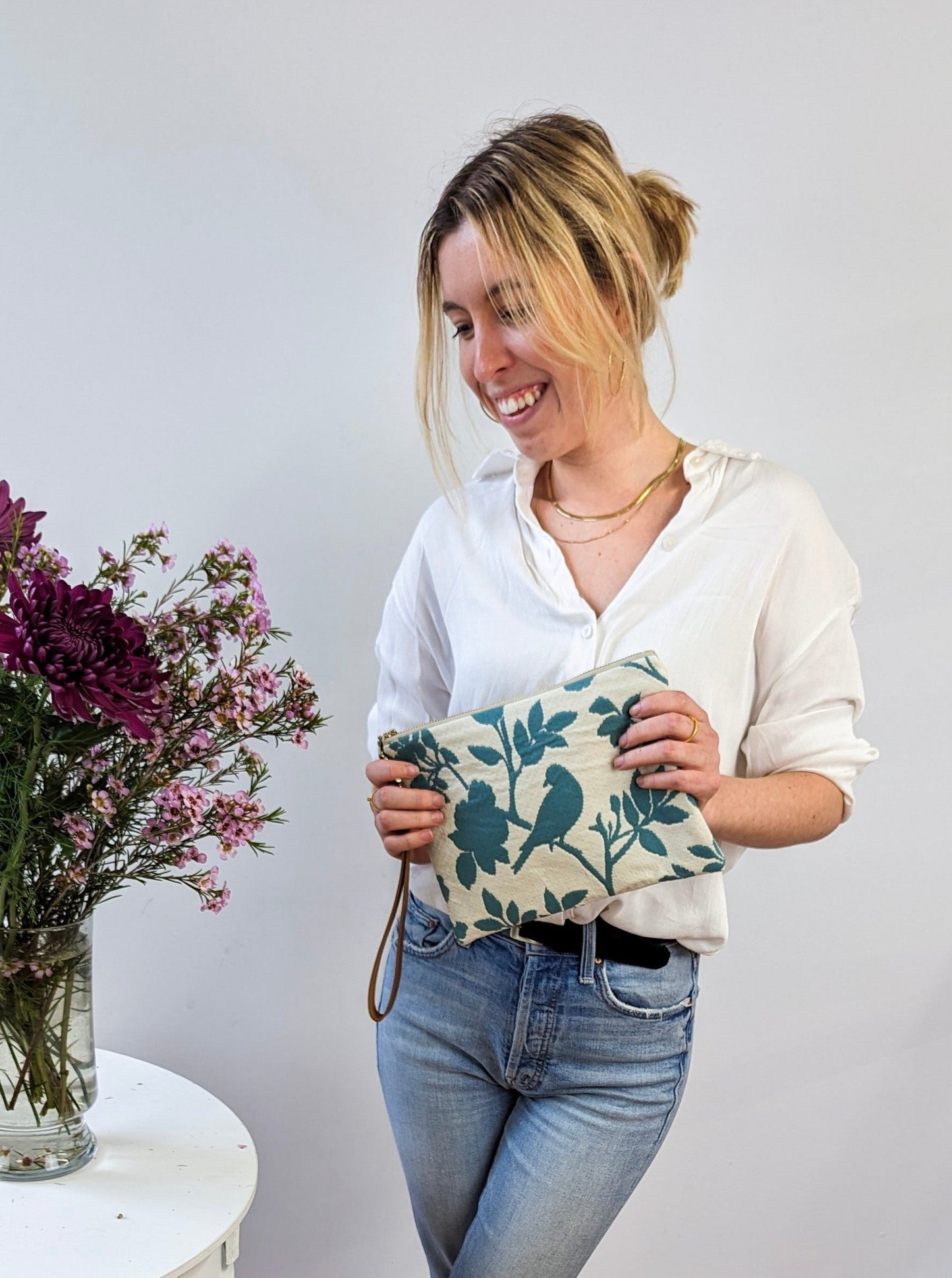 Ash & Rose bird silhouette wristlet purse featuring a stylish design, compact size, and convenient wrist strap for everyday use.