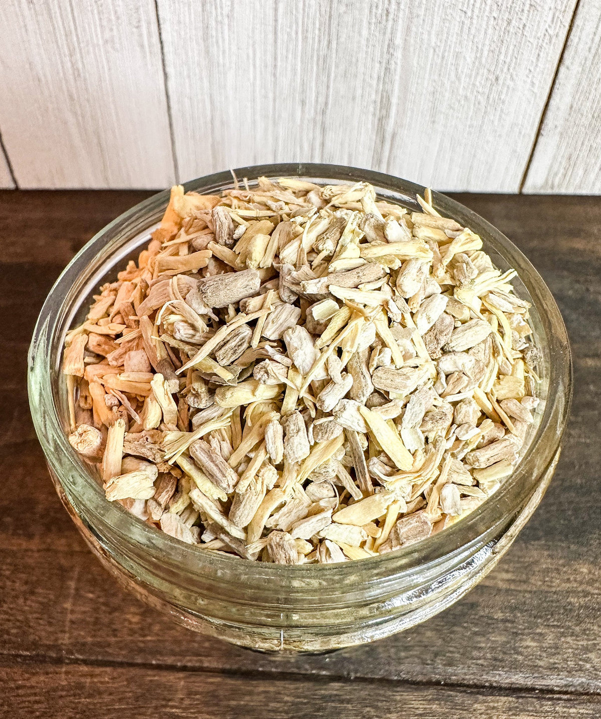 Small jar of dried ashwagandha root herbs in herbalroseapothecary herb jar, showcasing dried herb contents and jar label.