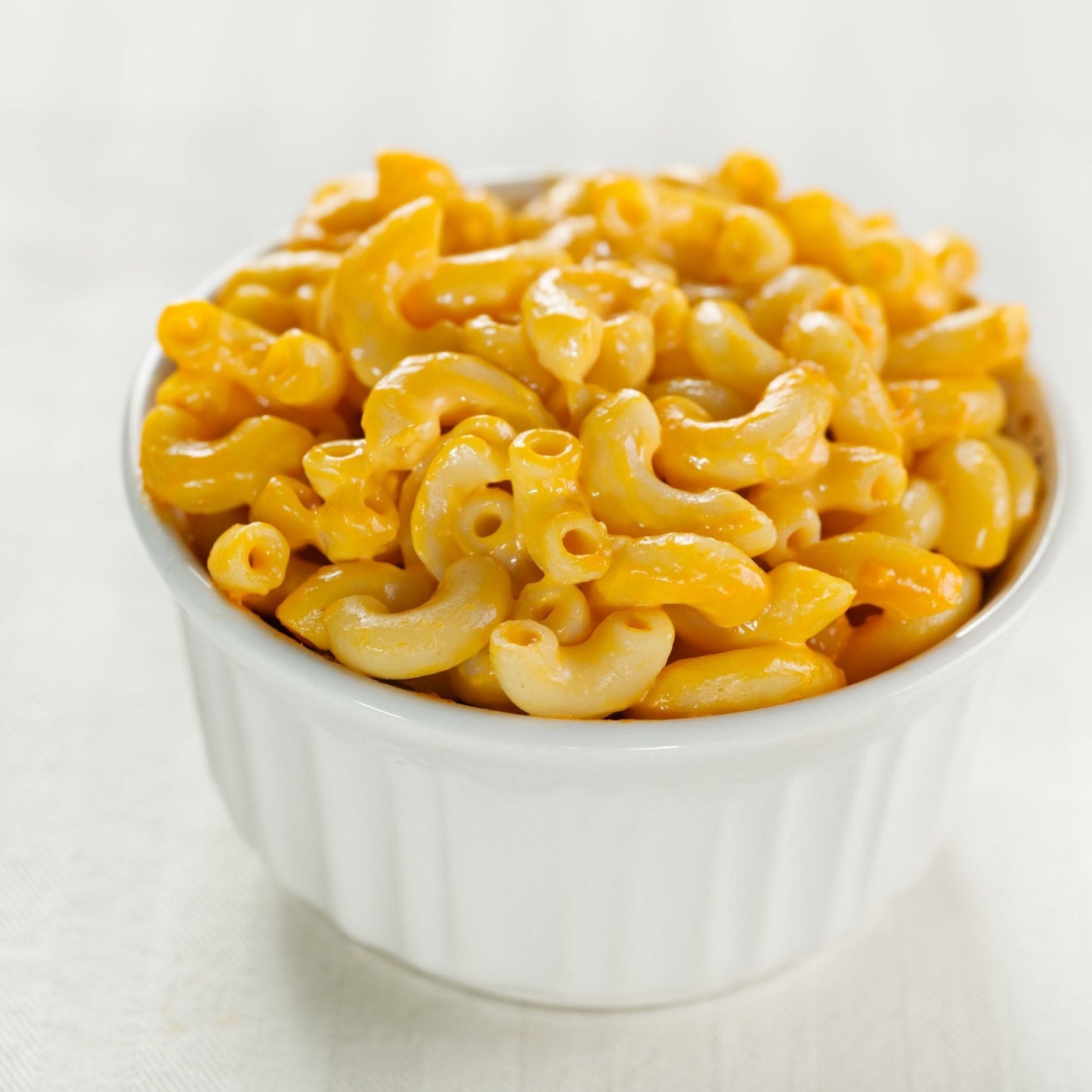Augason Farms cheese sauce mix can with 87 servings, showing a sealed can of cheesy sauce powder for cooking or topping.