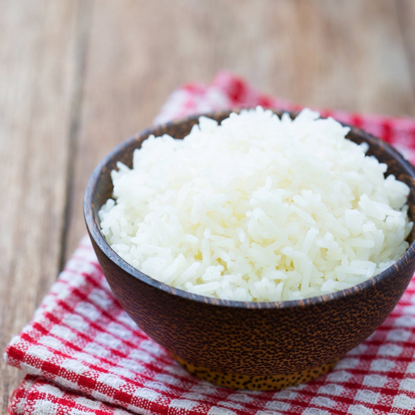Long grain white rice in a bulk container by Augason Farms, showing the packaged rice ready for storage or cooking.