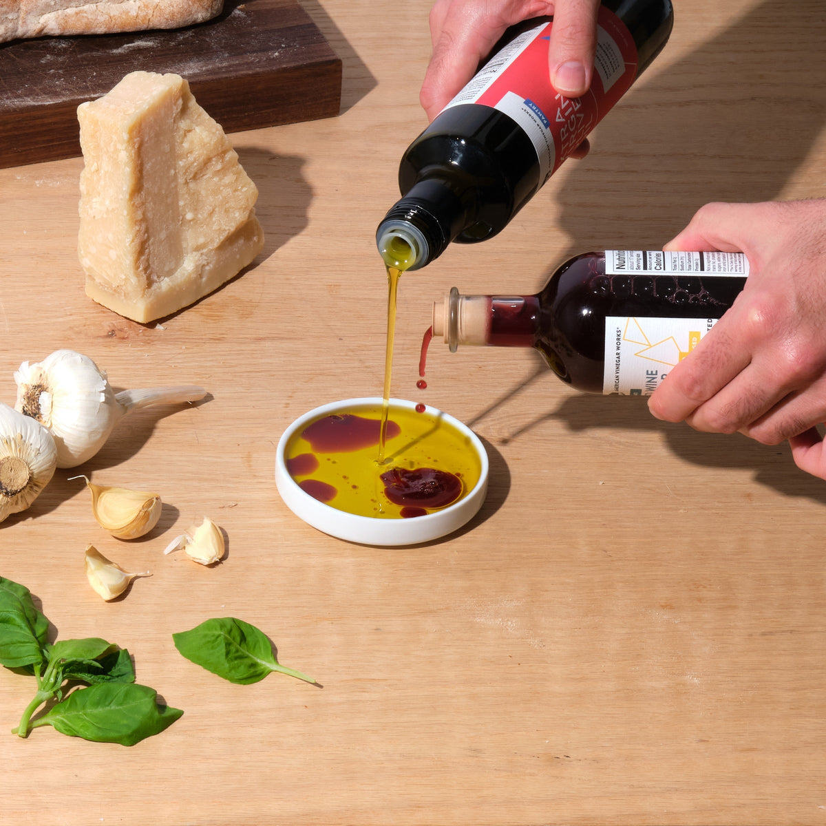 California organic extra virgin olive oil from American Vinegar Works, poured from a glass bottle with a golden hue.