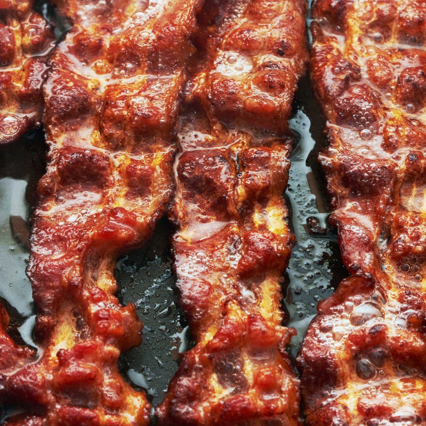Two pounds of small-batch bacon from Pig of the Month BBQ's Bacon of the Month Club, perfect for BBQ enthusiasts.