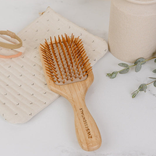 Bamboo hair brush from ZeroWasteStore.com with natural bamboo bristles and handle, eco-friendly comb for gentle hair detangling.