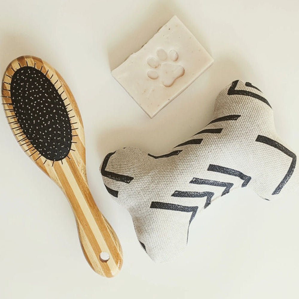 Tilley + Me two-sided dog grooming brush with bamboo handle, featuring bristle and wire sides for shedding and detangling.