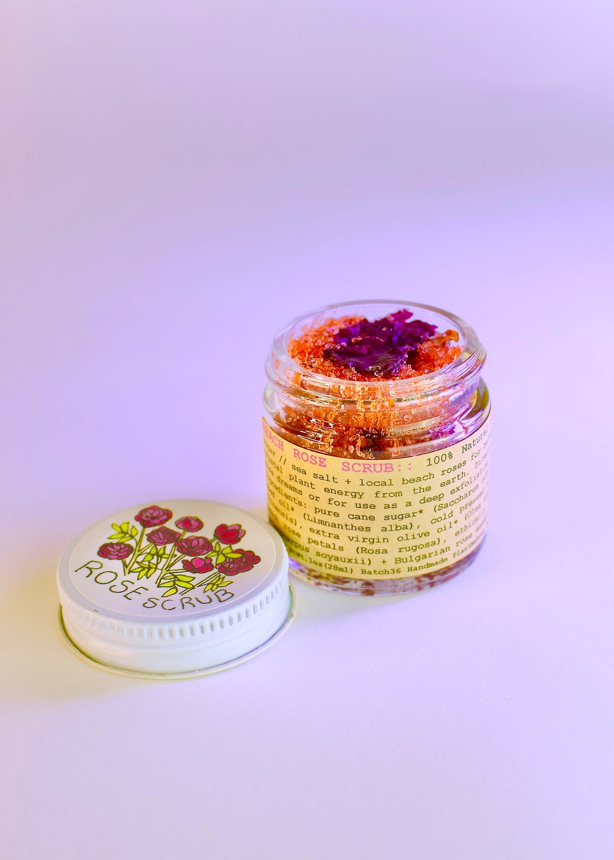 Plant Makeup Beach Rose Scrub in a jar with natural pink and beige exfoliating particles, showcasing its creamy texture and floral design.