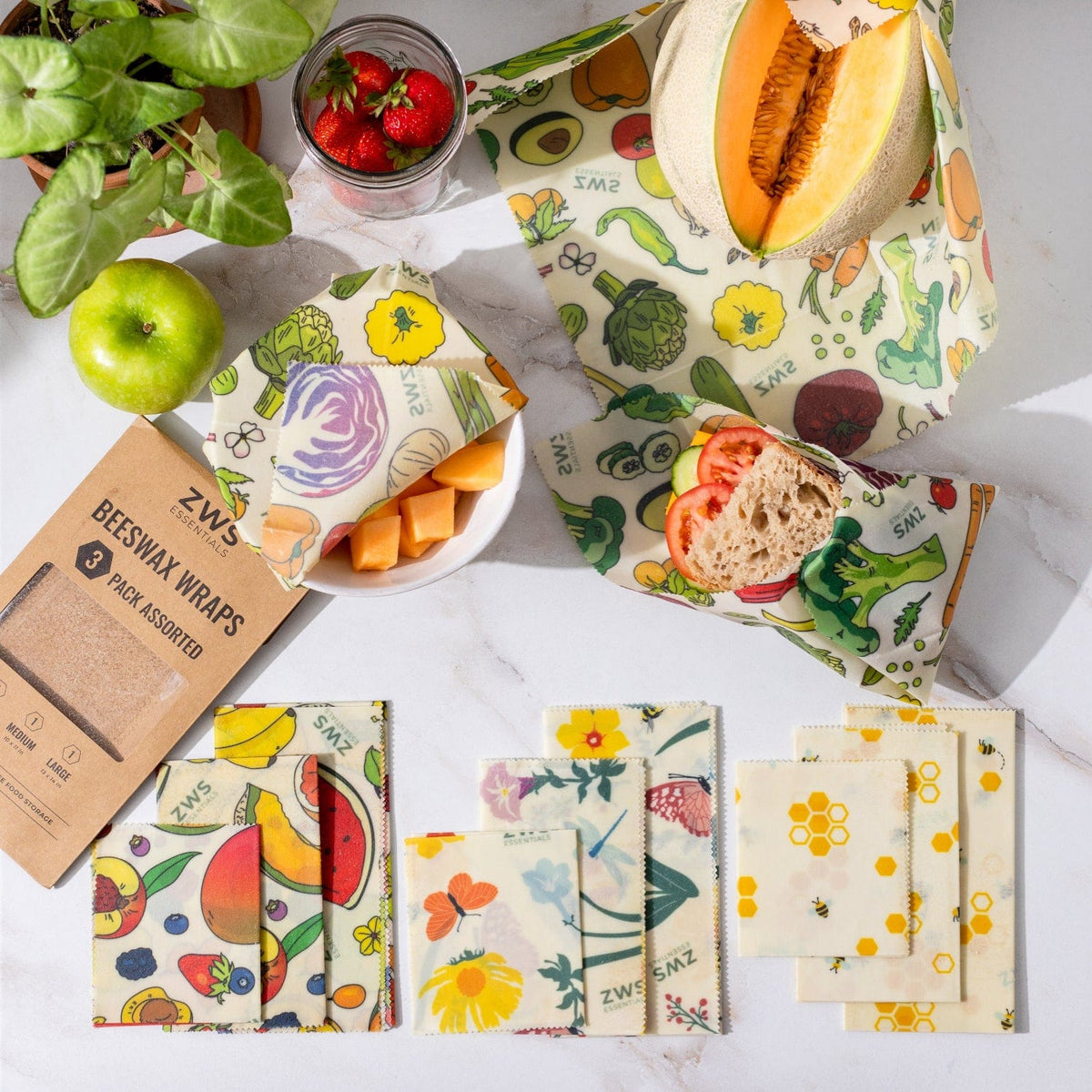 Three assorted beeswax food wraps from ZeroWasteStore.com, featuring colorful, eco-friendly, plastic-free food storage designs.