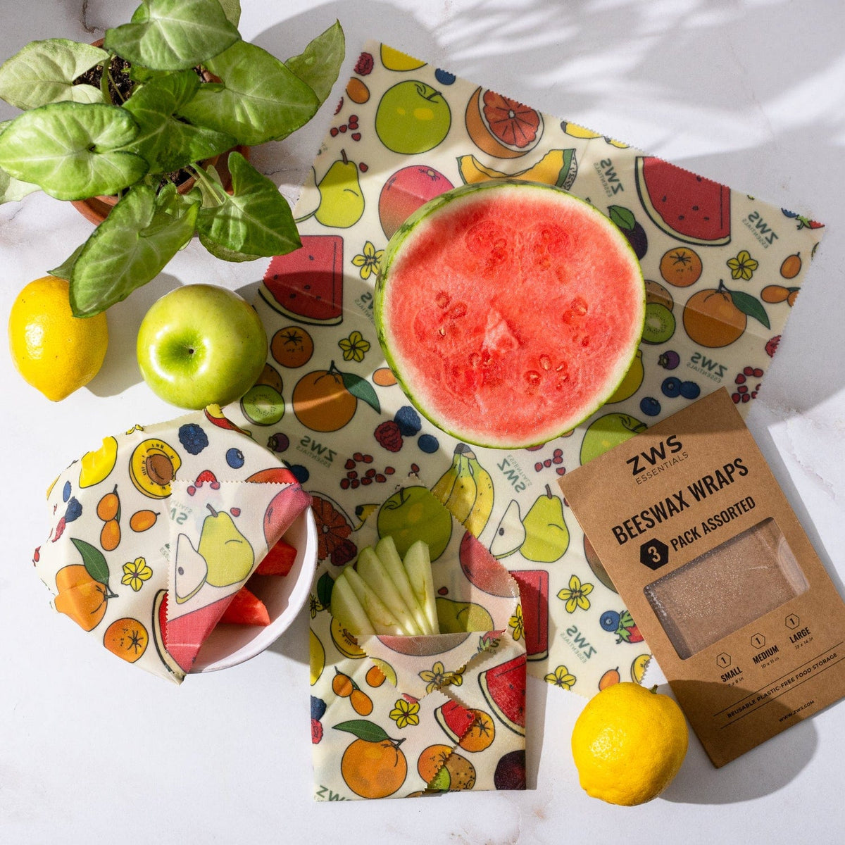 Assorted beeswax food wraps in a 3-pack for plastic-free food storage, featuring colorful fruit and vegetable patterns.
