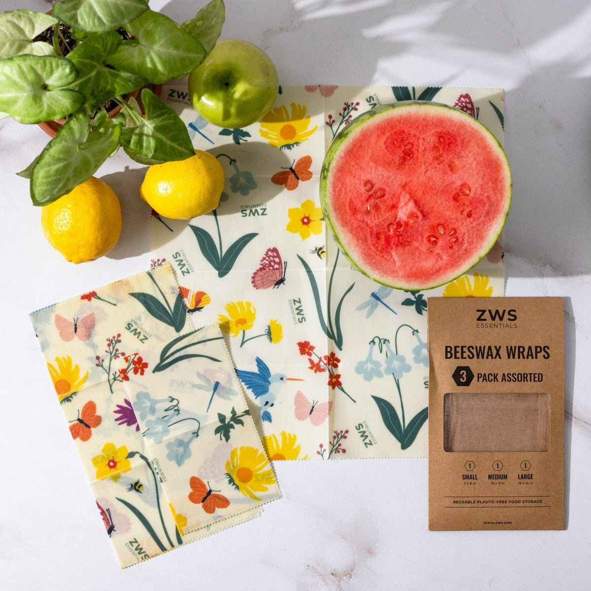 Set of three beeswax wraps in assorted sizes featuring pollinator designs, reusable plastic-free food storage by ZeroWasteStore.com.