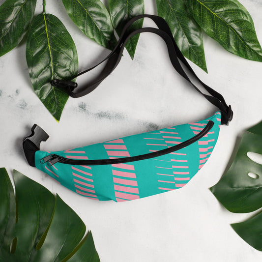 Pink and teal custom-designed Blessings Grow Meadows fanny pack with adjustable strap and colorful pattern, worn on a model.