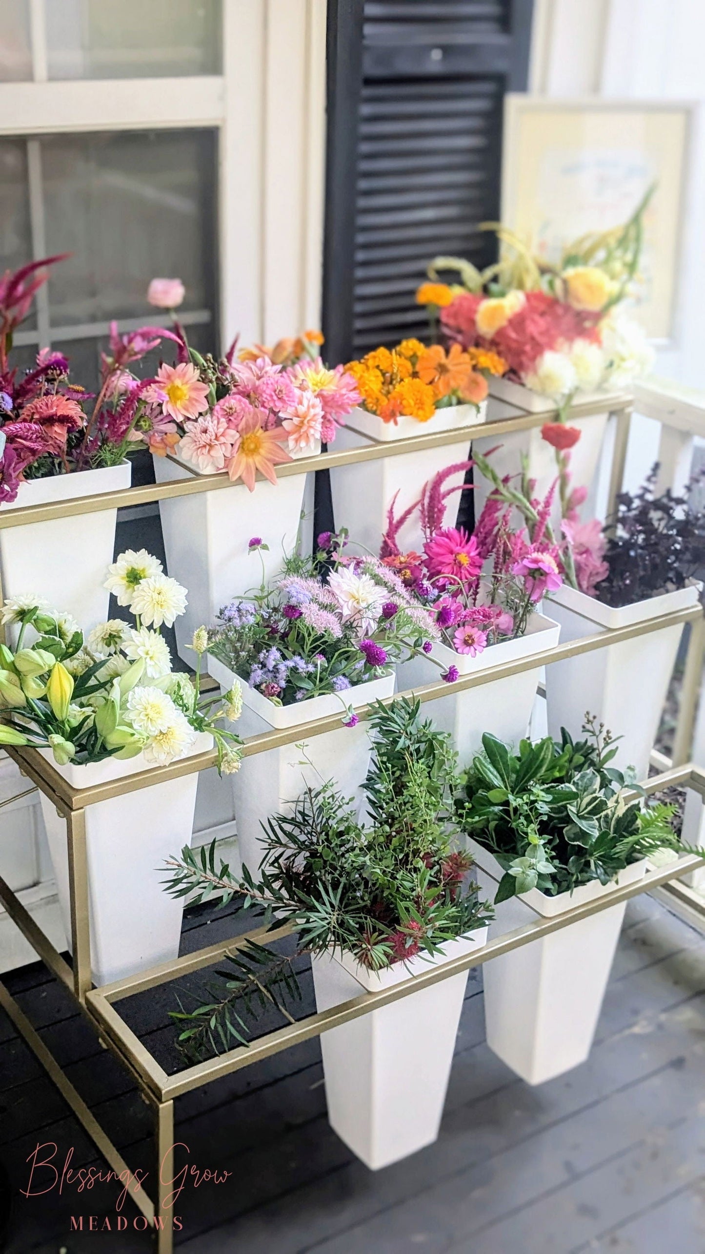 White flower display stand with buckets for event rental, used for floral arrangements, from Blessings Grow Meadows Merch & More.