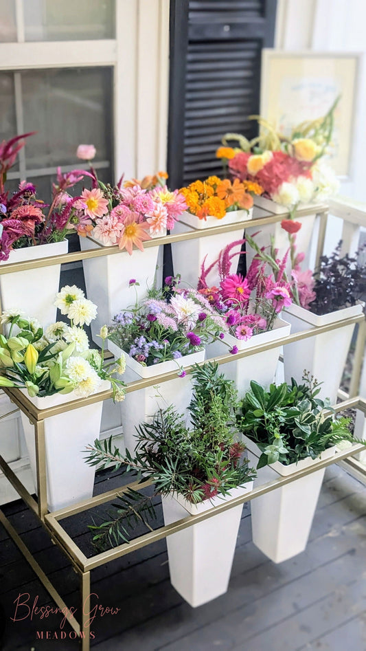 White flower display stand with buckets for event rental, used for floral arrangements, from Blessings Grow Meadows Merch & More.