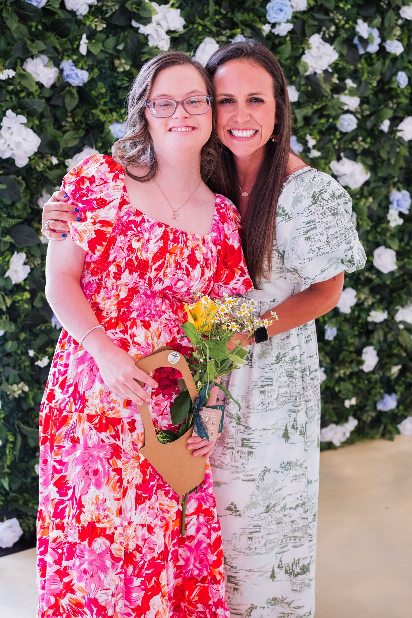 Artificial blue and white flower wall backdrop with rose accents on stand, 8x8 feet, for event rental by Blessings Grow Meadows Merch & More.