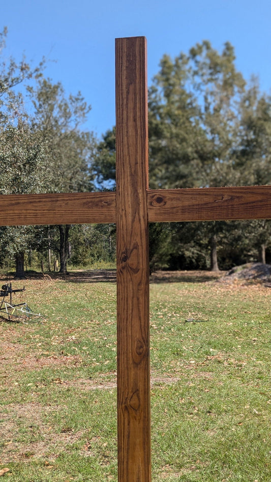 7-foot wooden mahogany ceremonial cross for rental, displayed outdoors, suitable for events and religious ceremonies.