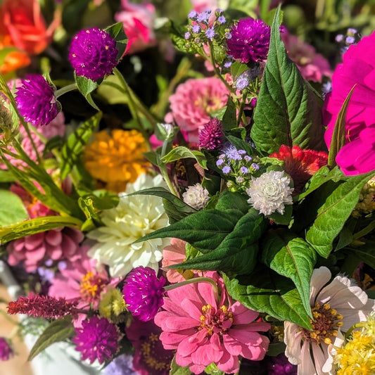 Multicolor DIY event flowers and fresh greenery in bloom buckets, by Blessings Grow Meadows Merch & More, ready for pick-up in Metter, GA.