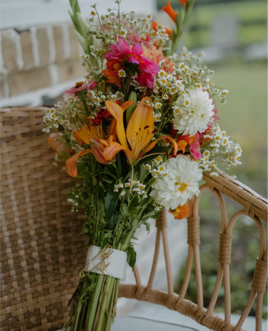 Colorful DIY event flowers and fresh greenery in bloom buckets from Blessings Grow Meadows for bulk floral arrangements.