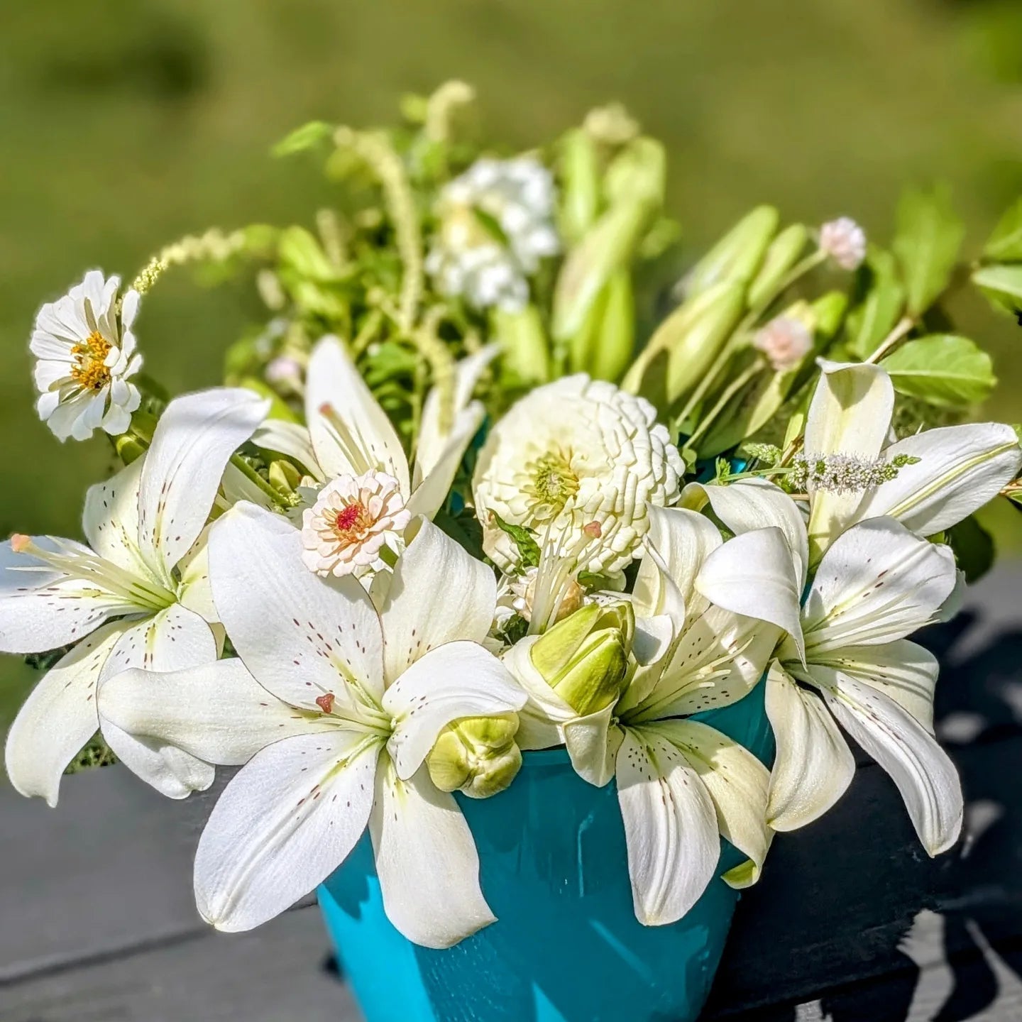 Colorful DIY event flowers and fresh greenery in bloom buckets from Blessings Grow Meadows for bulk floral arrangements.