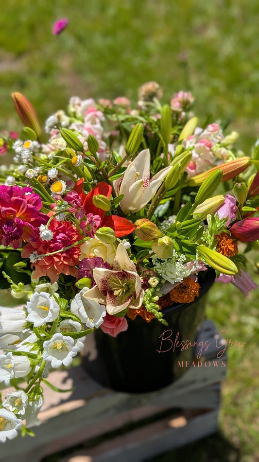Multicolor DIY event flowers and fresh greenery in bloom buckets from Blessings Grow Meadows for bulk floral arrangements.
