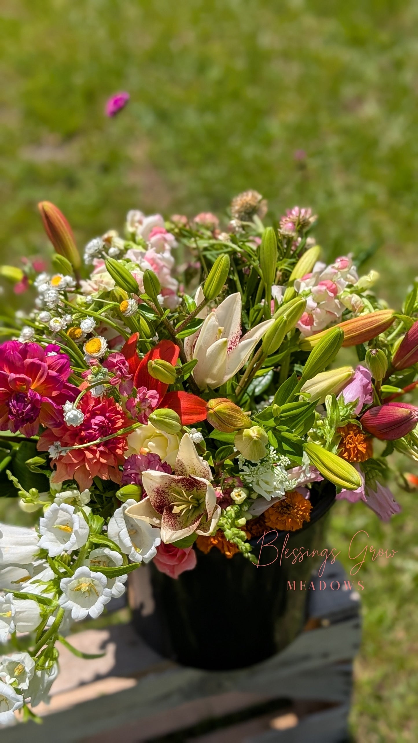 Colorful DIY event flowers and fresh greenery in bloom buckets from Blessings Grow Meadows for bulk floral arrangements.