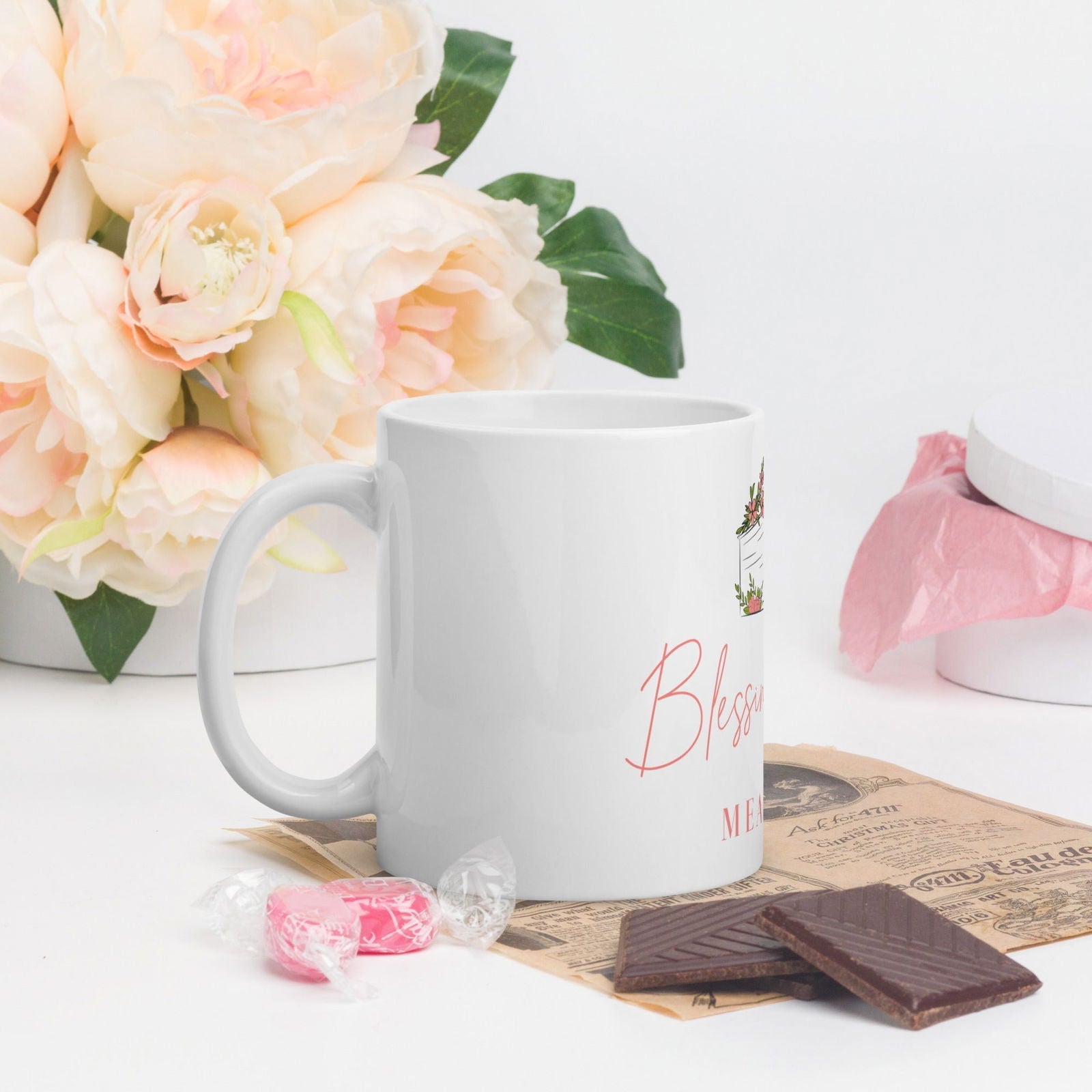 White glossy Blessings Grow Meadows mug with a simple, elegant design, perfect for daily use and showcasing the Blessings Grow Merch branding.