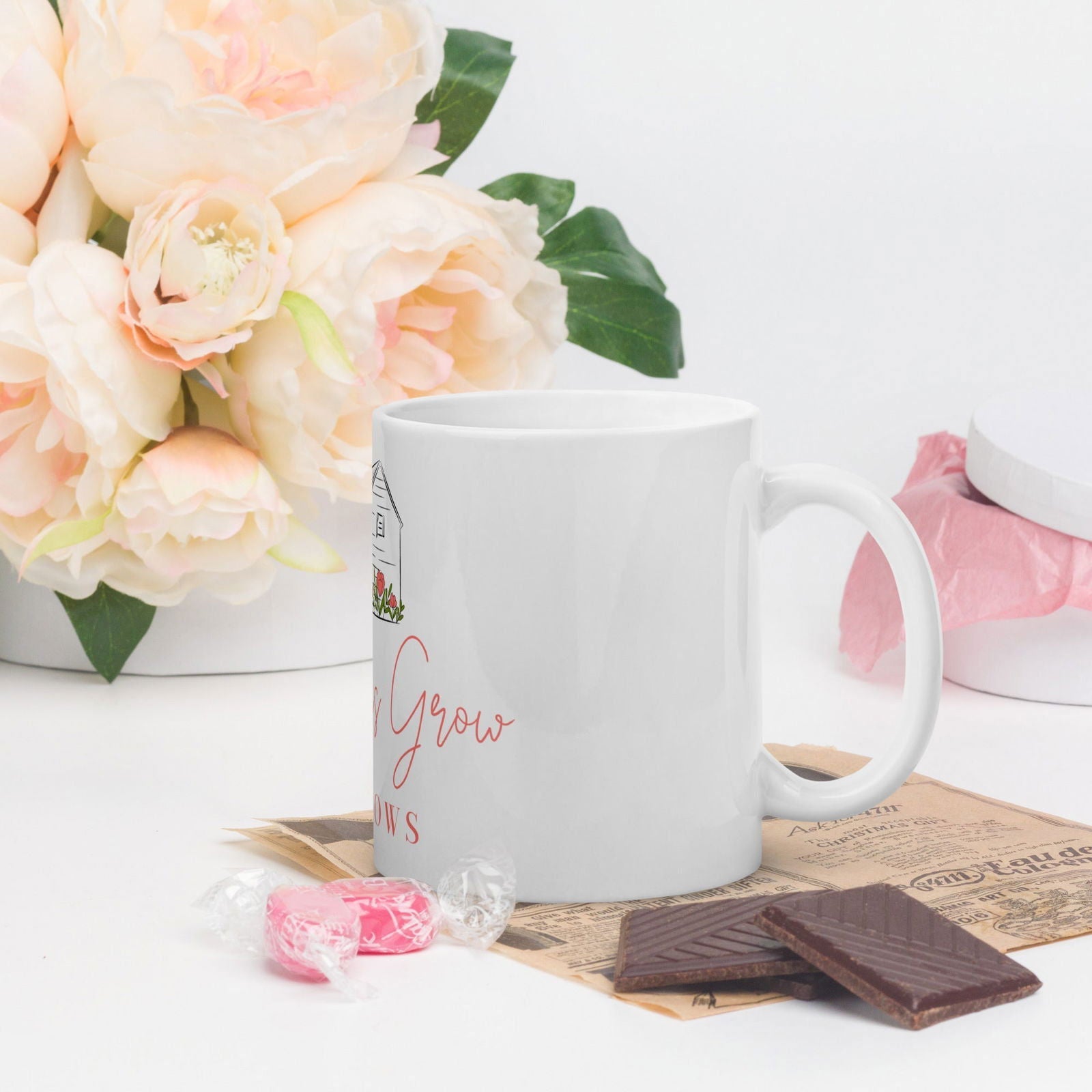 White glossy Blessings Grow Meadows mug with "Blessings Grow" text, 11 oz ceramic mug for hot beverages.