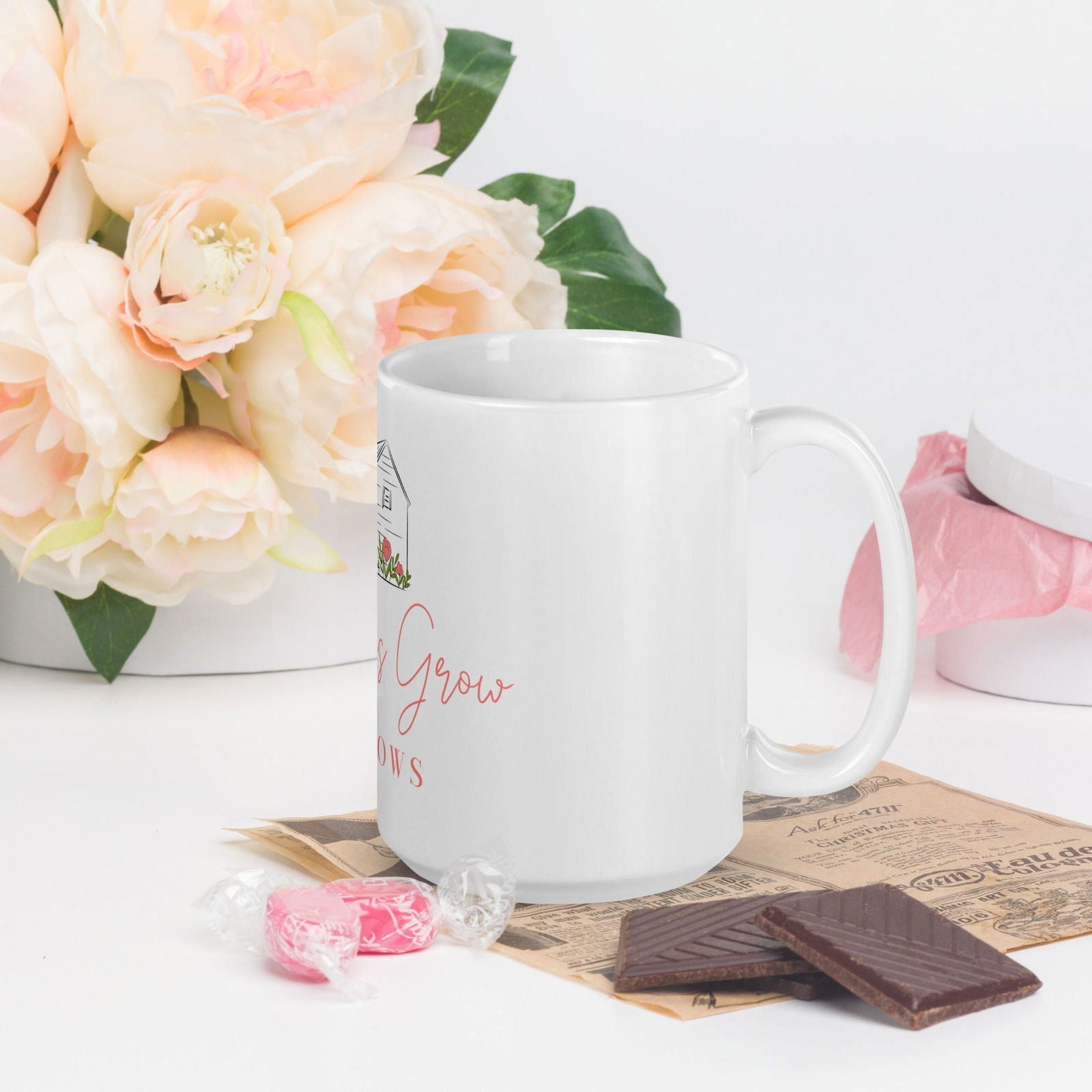 White glossy Blessings Grow Meadows mug with a simple, elegant design, perfect for enjoying hot beverages.