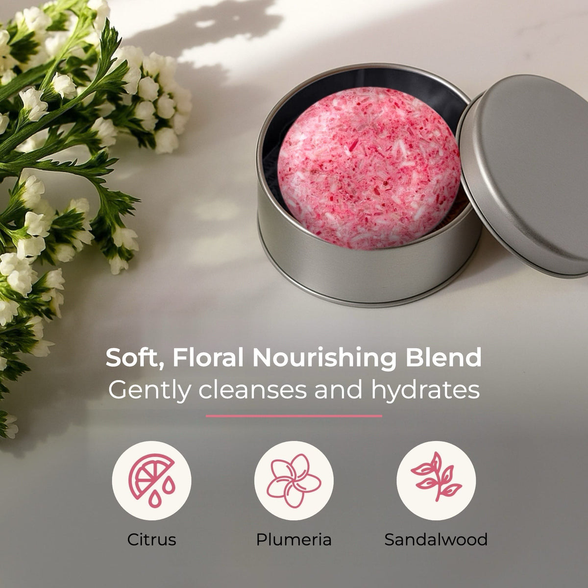 ZeroWasteStore.com blossom shampoo bar with floral scent, shown with its packaging and natural ingredients.
