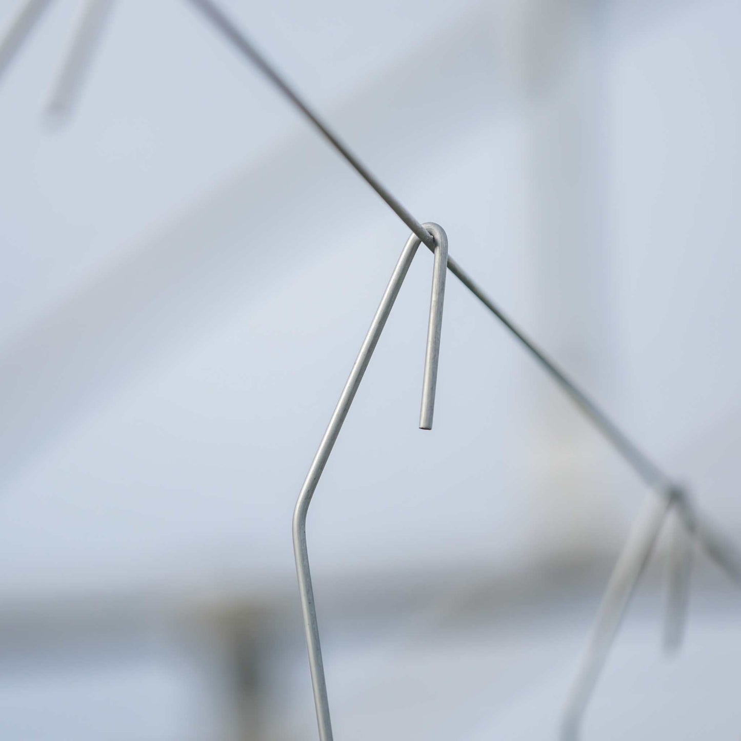 Qlipr Trellising System by Bootstrap Farmer, with multiple plastic clips for supporting climbing plants in gardening or farming.