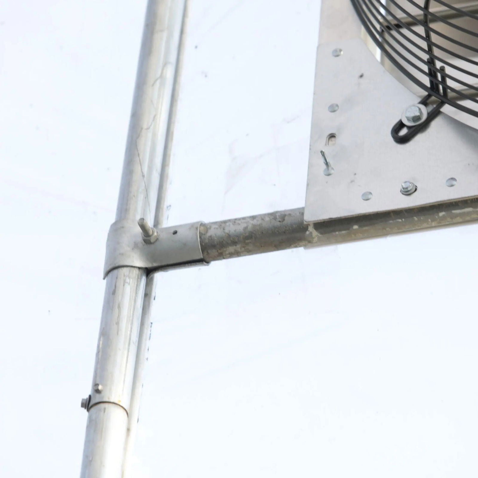 Greenhouse shutter mount exhaust fan by Bootstrap Farmer, 12-inch size, with green housing and mounting brackets for ventilation.
