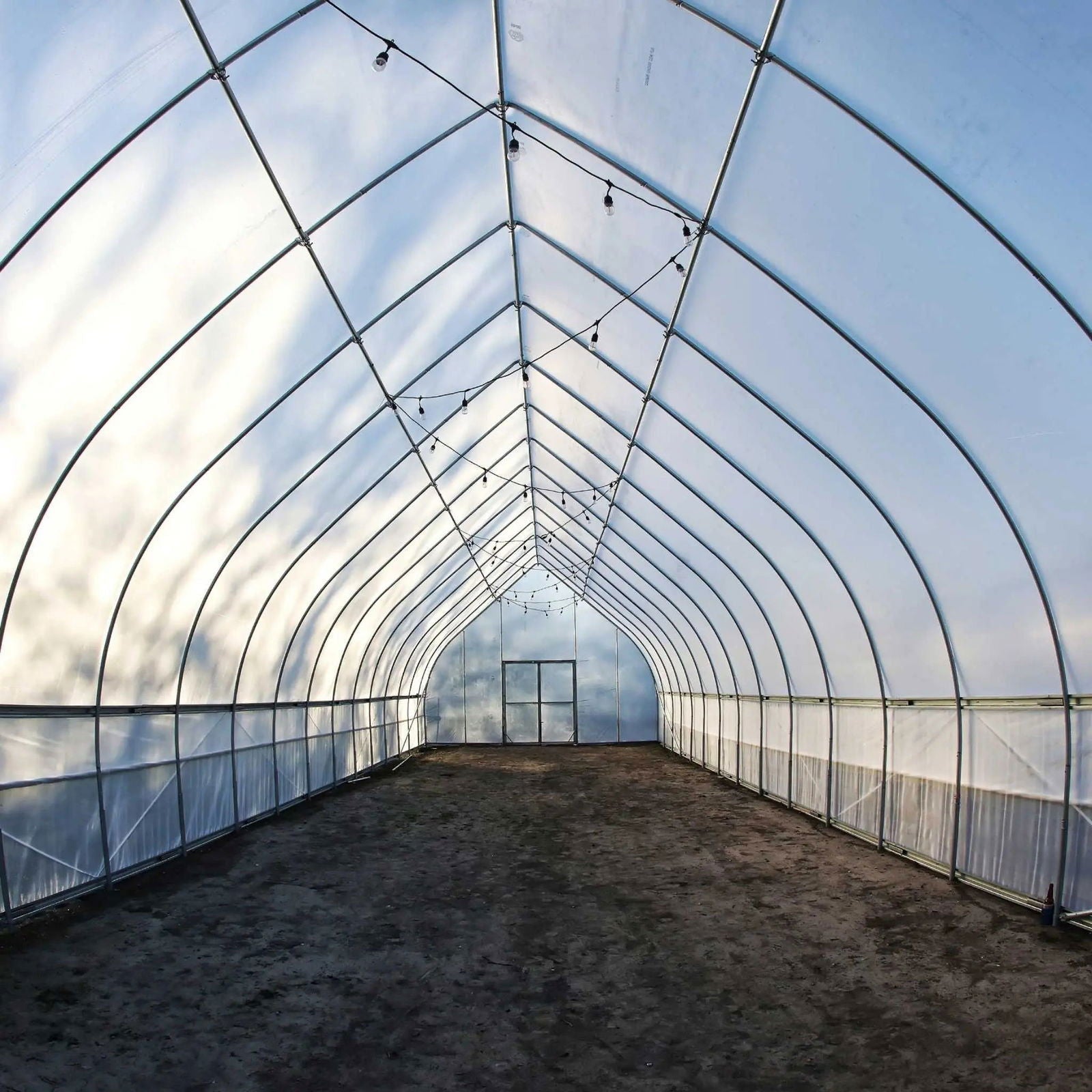 Gothic all-metal hoop house greenhouse kit by Bootstrap Farmer with sturdy metal framing and plastic covering for plant protection.