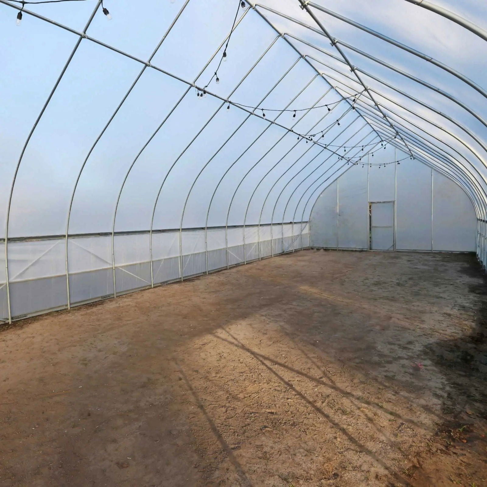 Gothic all-metal hoop house greenhouse kit by Bootstrap Farmer with durable metal framework and transparent plastic covering