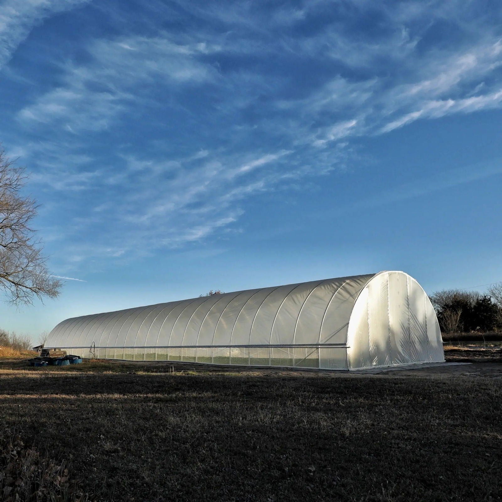 All-metal round hoop house kit for greenhouse gardening by Bootstrap Farmer, featuring sturdy metal frame and clear plastic cover.