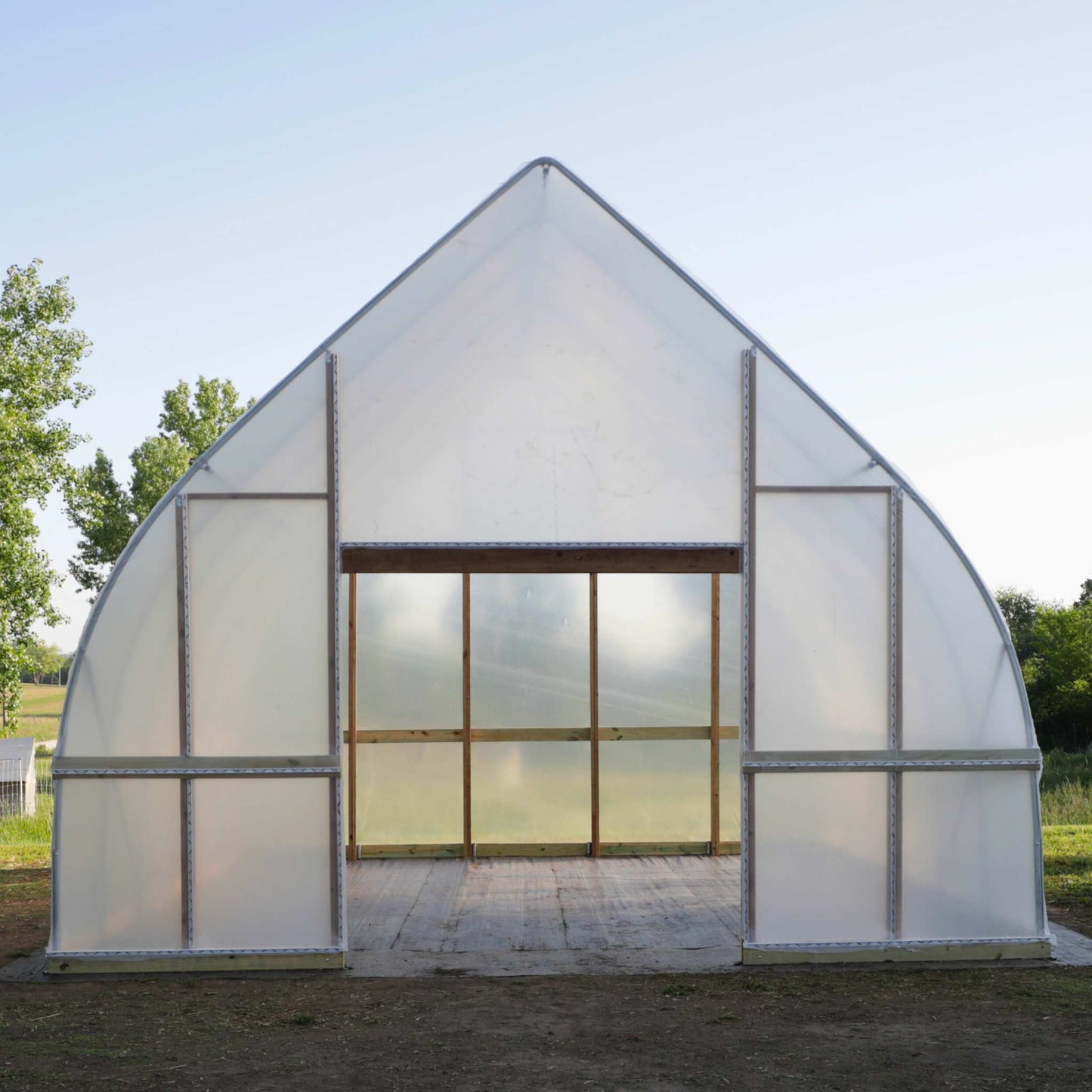 DIY Gothic Greenhouse Kit by Bootstrap Farmer, featuring sturdy frame and clear panels for easy assembly and greenhouse gardening.