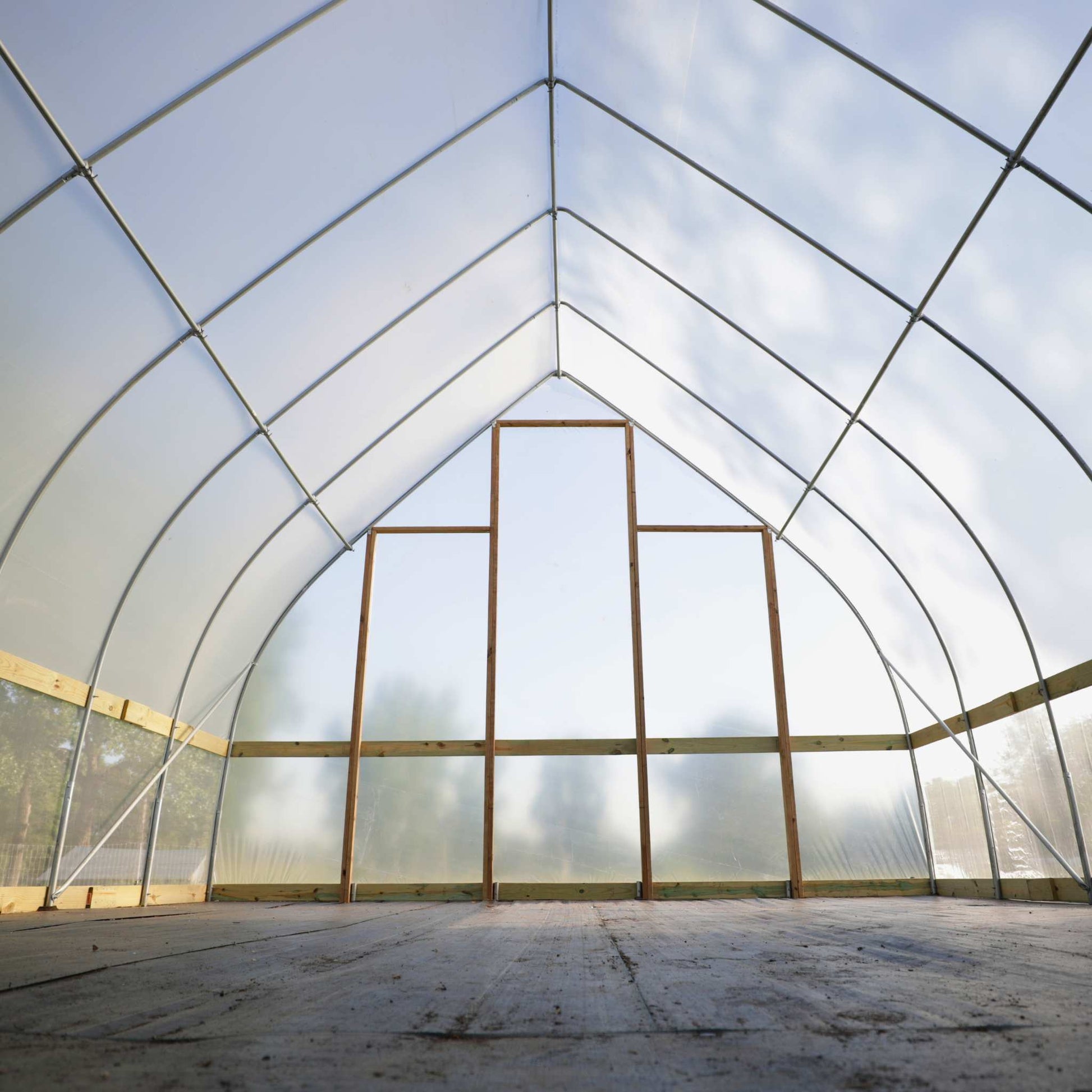 DIY Gothic Greenhouse Kit by Bootstrap Farmer, featuring a sturdy frame and clear panels for home gardening and plant protection.