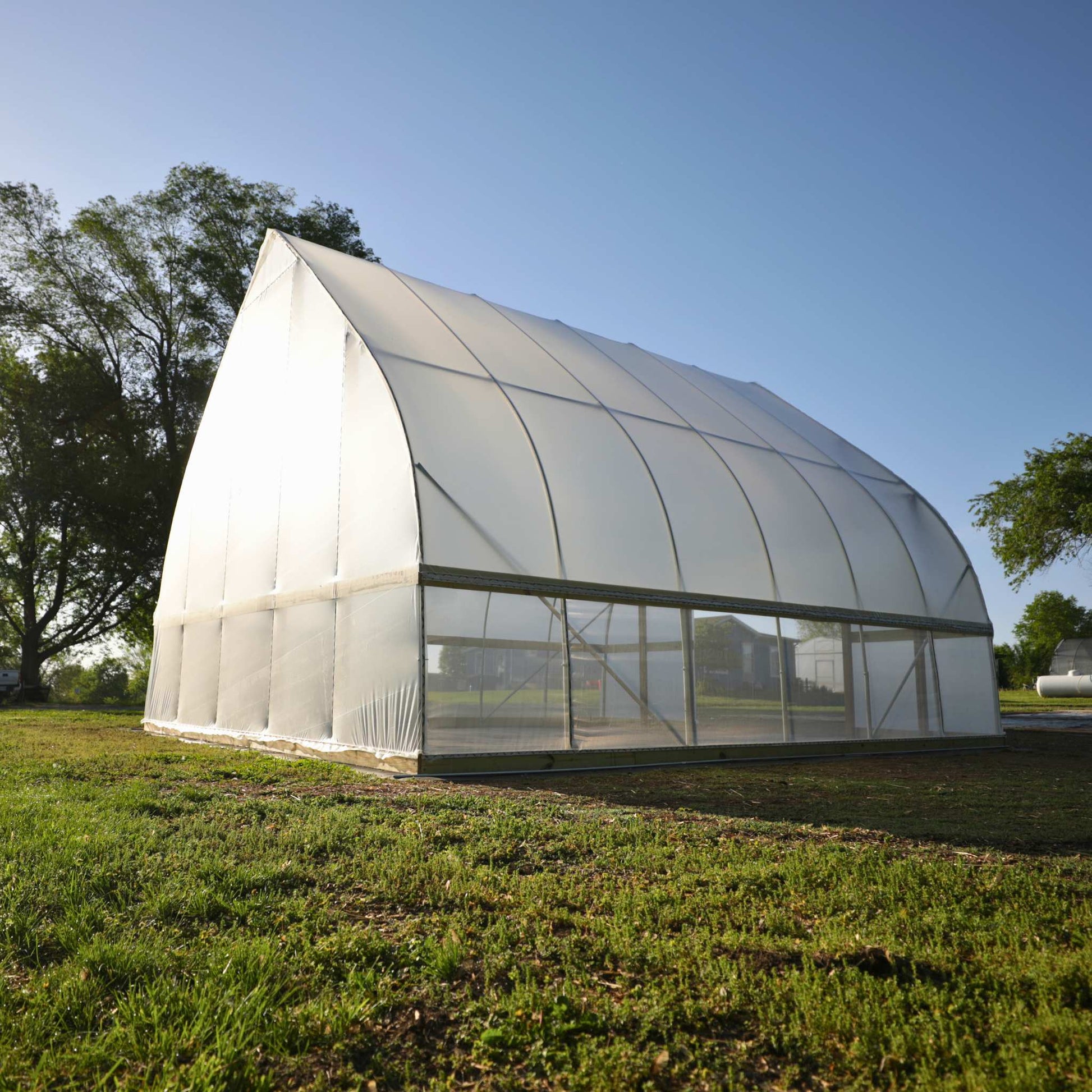 DIY Gothic Greenhouse Kit by Bootstrap Farmer featuring a sturdy green metal frame and clear panels for plant protection.