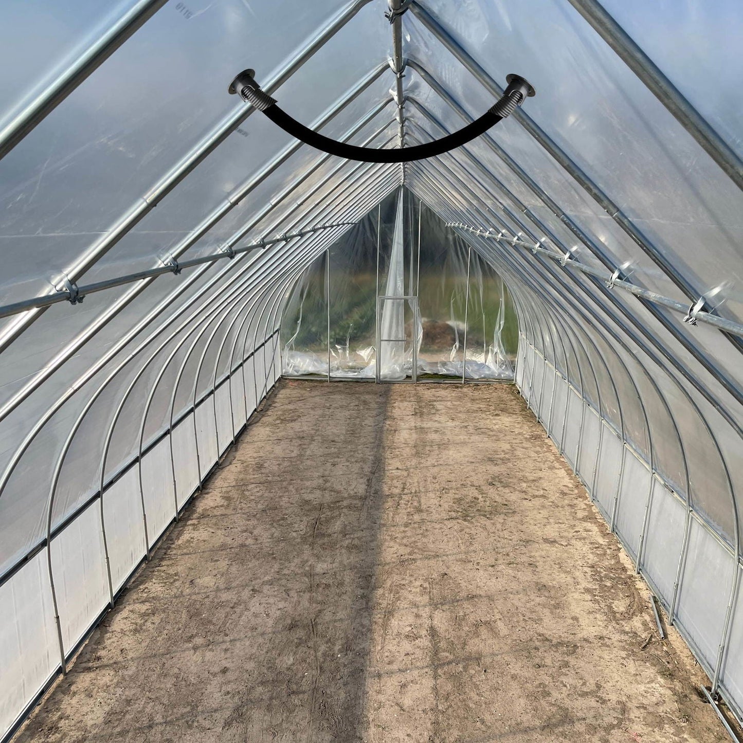 Greenhouse kit with Bootstrap Farmer's air inflation jumper hose, featuring a flexible green hose for efficient greenhouse inflation.