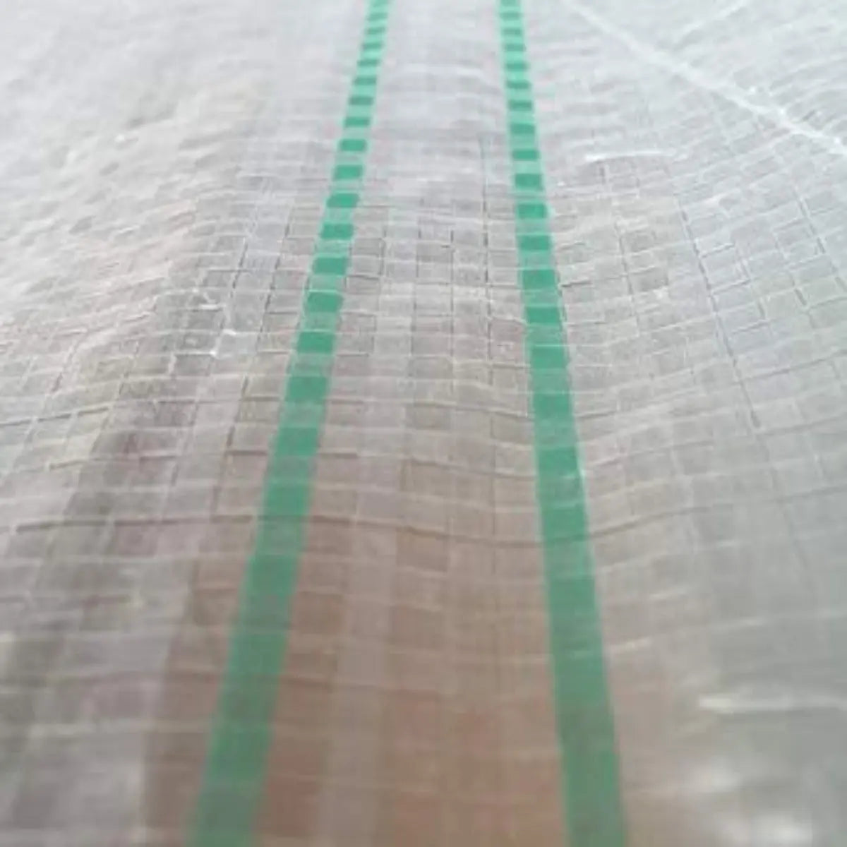 Greenhouse woven plastic film by Bootstrap Farmer, 11 mil Solarig 182, for durable plant protection and greenhouse insulation.