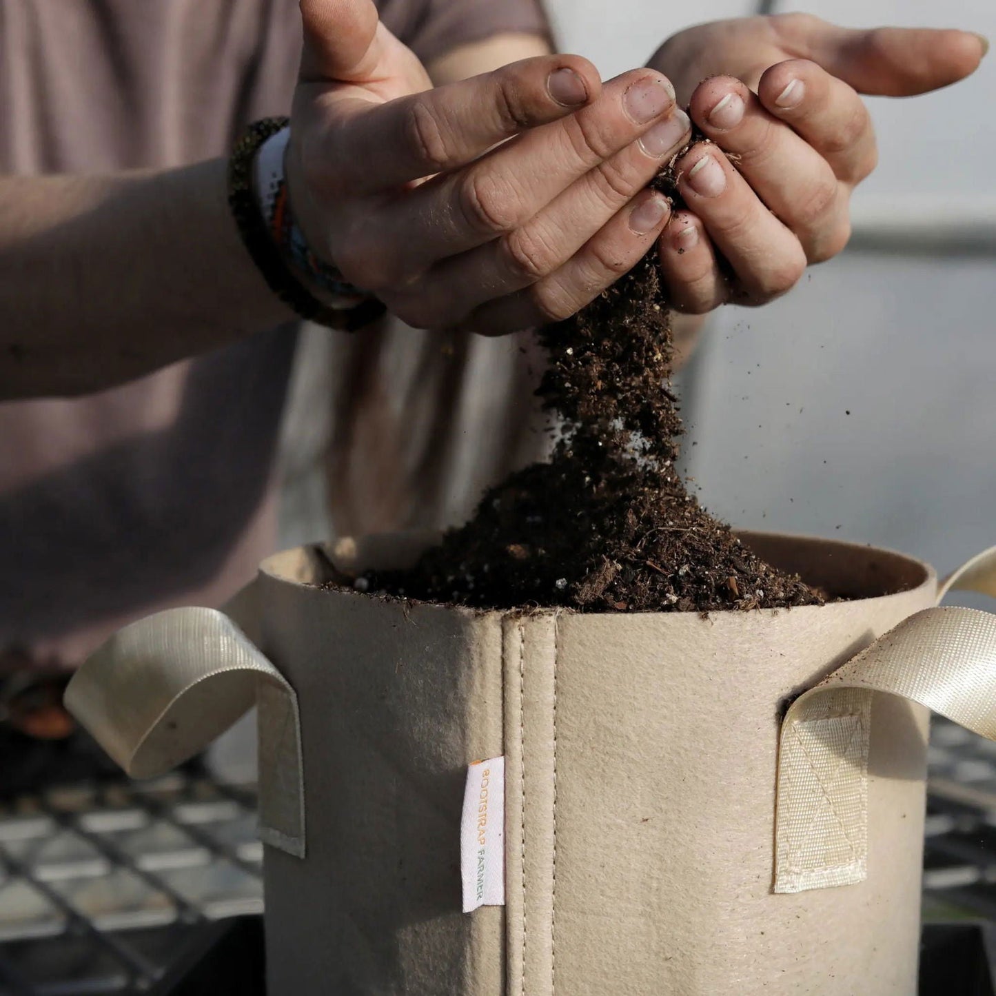 Two tan Bootstrap Farmer 2-gallon grow bags for gardening, made of durable fabric for healthy plant growth.