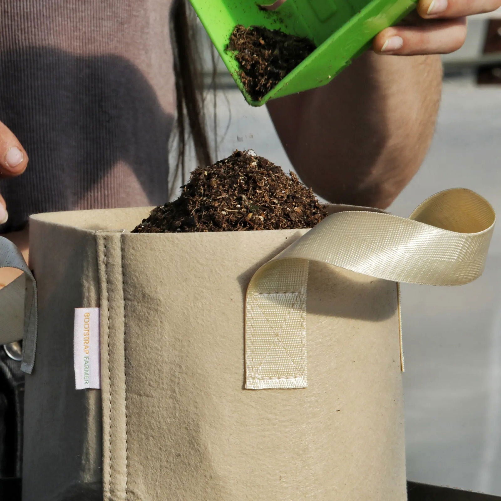 Set of ten tan Bootstrap Farmer 2-gallon grow bags for gardening and plant cultivation.