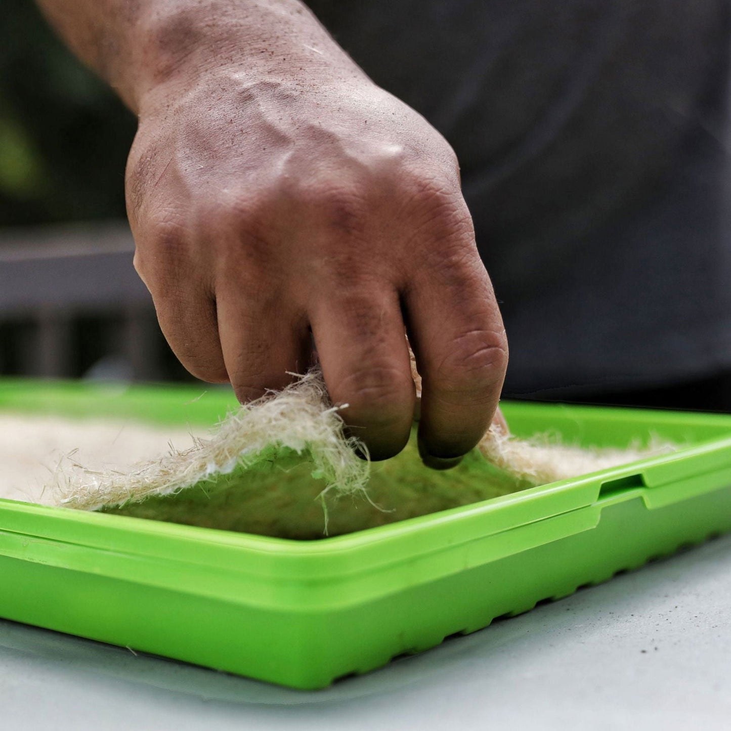 Bootstrap Farmer hemp grow mats, durable growing media for gardening and hydroponics, arranged in a stack on a work surface.