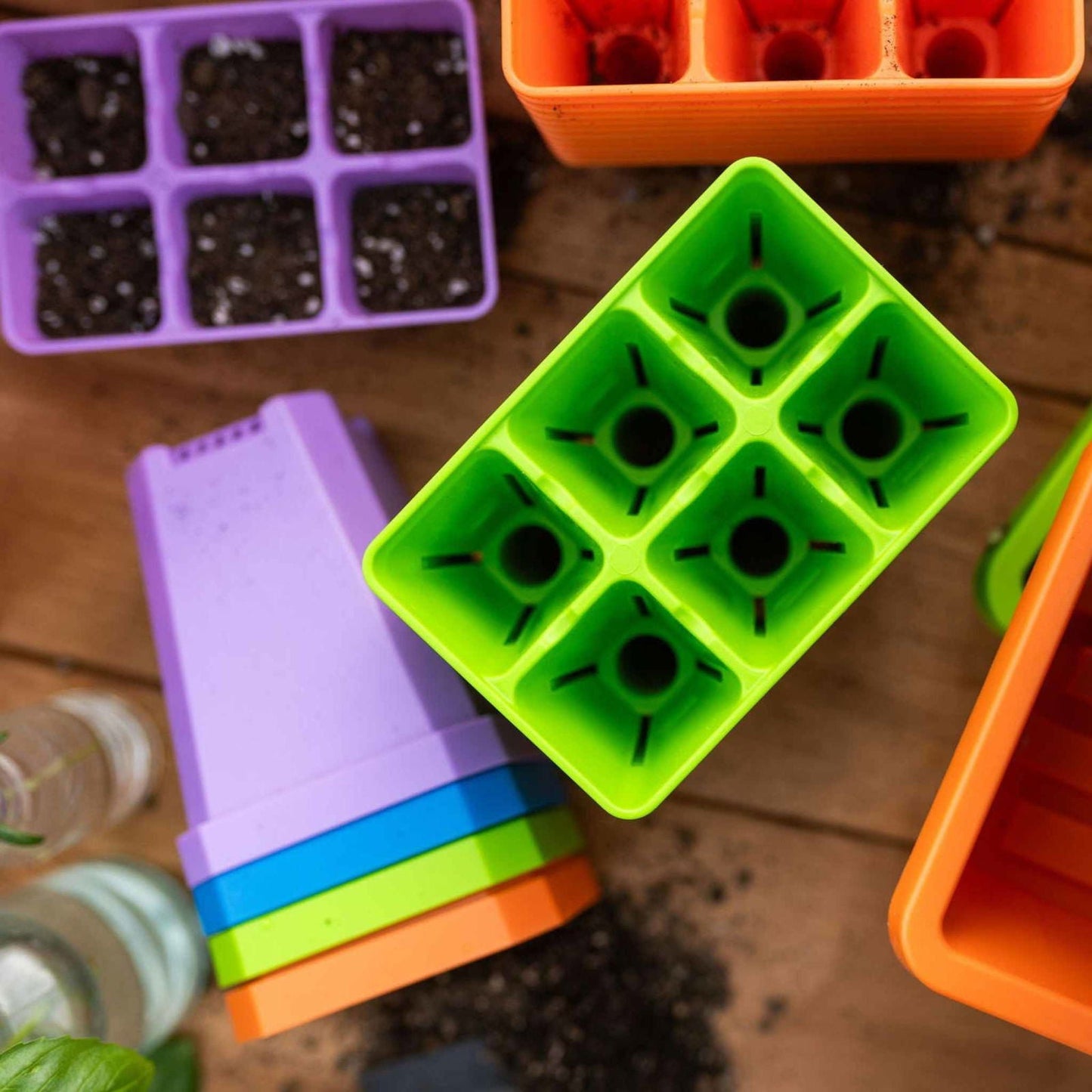 Colorful Bootstrap Farmer pots with humidity domes in the Ultimate Backyard Gardener Bundle for indoor and outdoor planting.