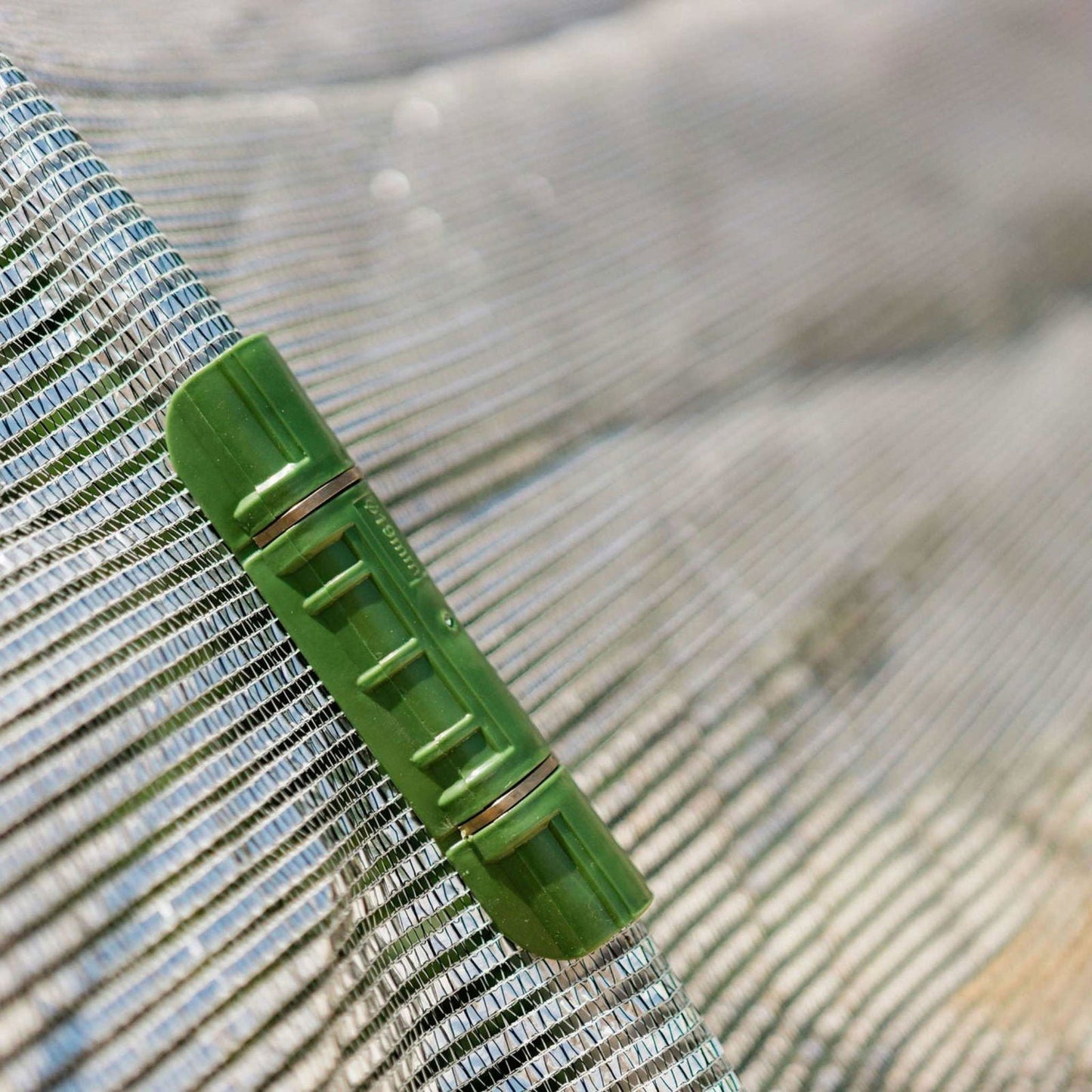 Aluminum white shade cloth from Bootstrap Farmer, 50% shade, outdoor gardening and sun protection, close-up of fabric texture.