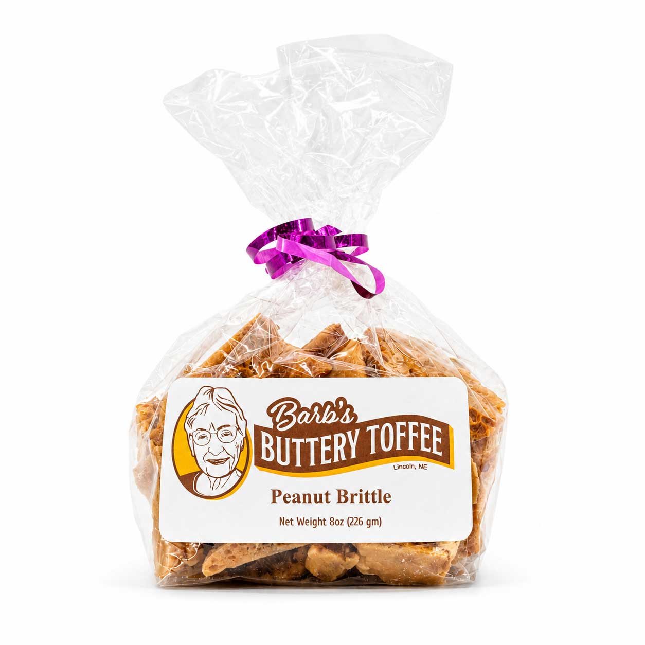 Homemade peanut brittle by Barb's Buttery Toffee, 8 oz, golden caramelized peanuts and crunchy toffee on a white background.