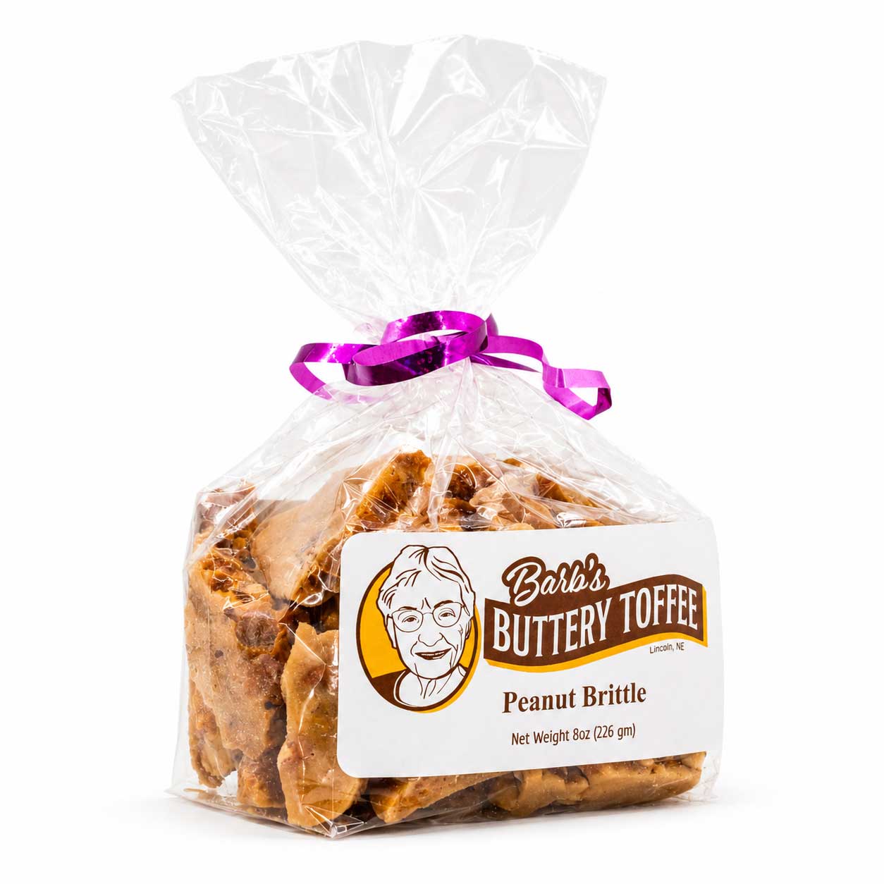 Homemade peanut brittle by Barb's Buttery Toffee in an 8 oz package, featuring golden caramelized peanuts and crispy toffee pieces.