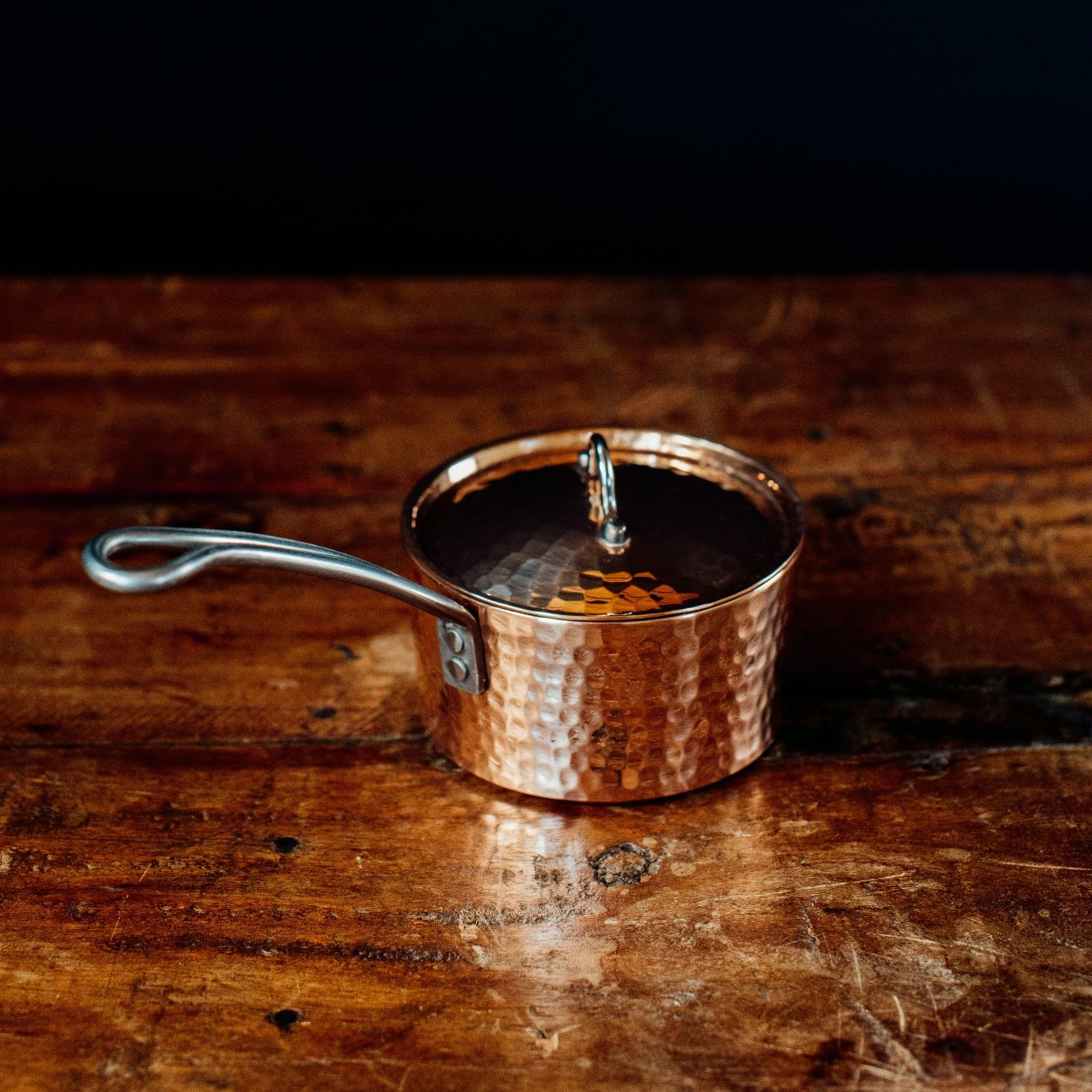 Petite French copper butter pot with lid by Sertodo, featuring a handle and traditional design, ideal for storing and serving butter.