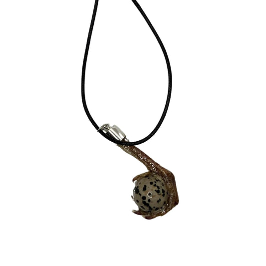 Quail foot necklace with a stone resembling a quail egg, featuring natural stone details and a delicate chain.