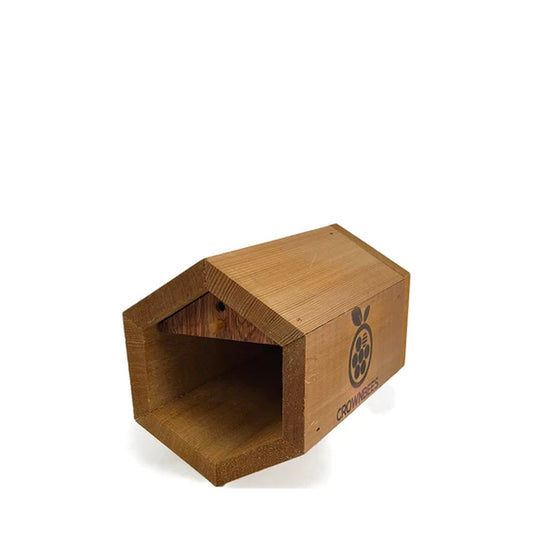 Small hexagonal bee house by CrownBees with wooden frame and multiple nesting compartments for native bees.